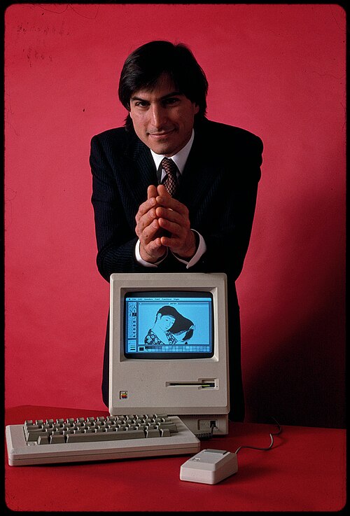 Steve Jobs leaning forward with his hands together, 1984